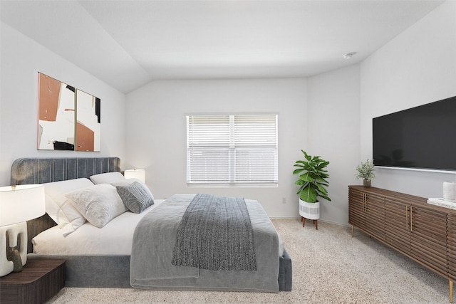 bedroom featuring carpet flooring and vaulted ceiling