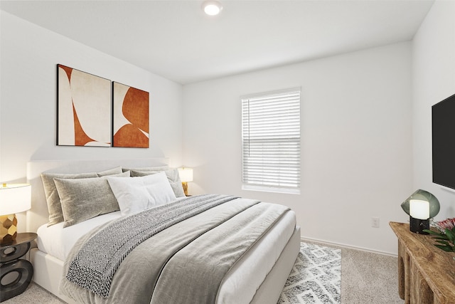 bedroom featuring light carpet