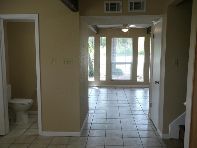 corridor with light tile patterned floors