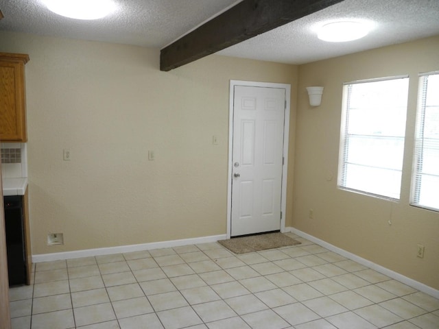 interior space with a textured ceiling and beam ceiling