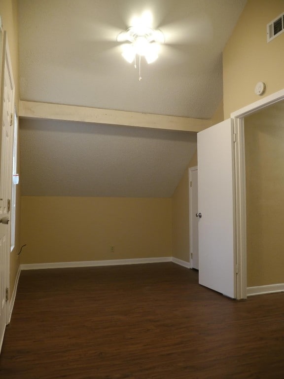 bonus room featuring dark hardwood / wood-style flooring and vaulted ceiling