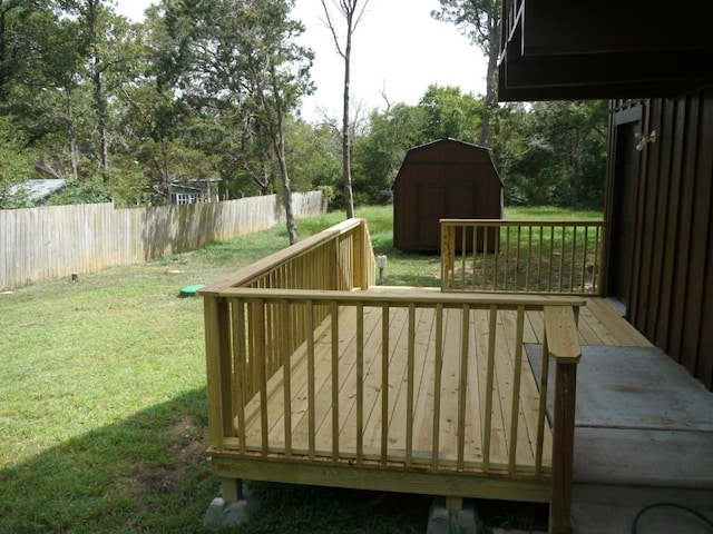 deck featuring a yard and a shed