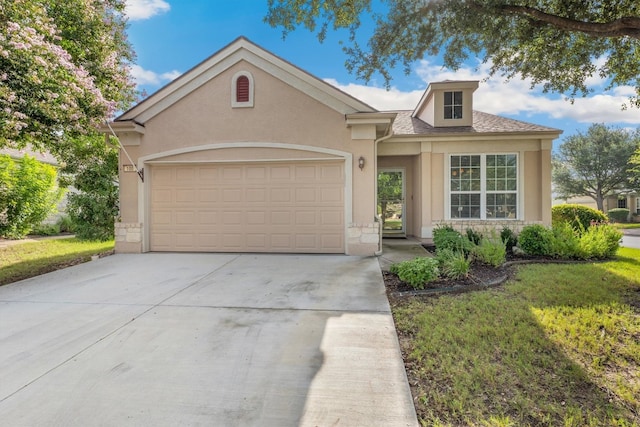 view of front of property with a garage and a front yard