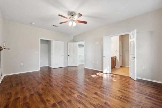 unfurnished bedroom with ceiling fan, ensuite bath, and hardwood / wood-style flooring