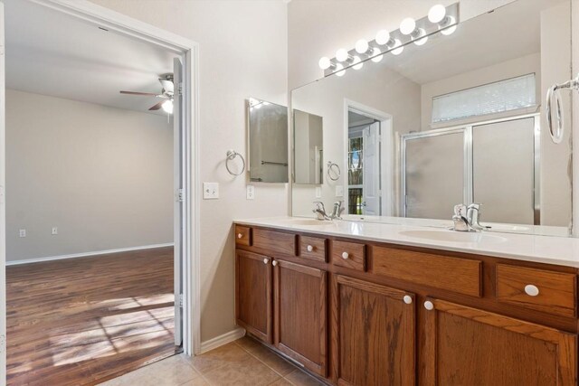 bathroom with dual vanity, ceiling fan, and hardwood / wood-style flooring