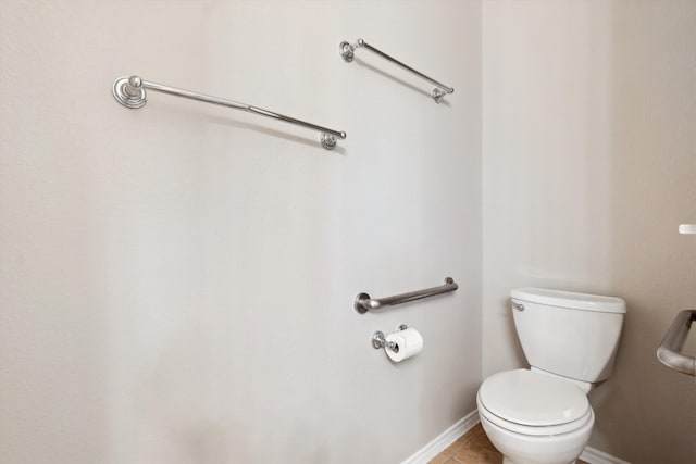 bathroom with toilet and tile patterned flooring