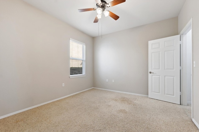 carpeted spare room with ceiling fan