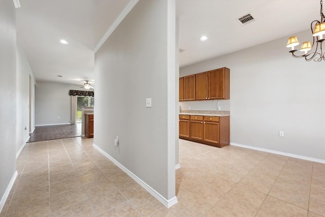 hallway featuring light tile patterned floors and a chandelier