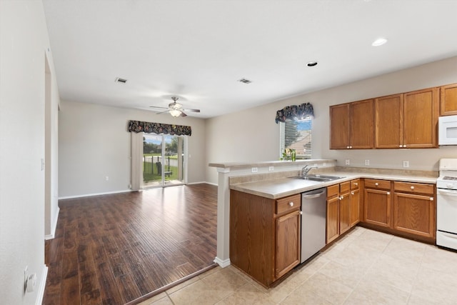 kitchen featuring ceiling fan, kitchen peninsula, light hardwood / wood-style floors, white appliances, and sink