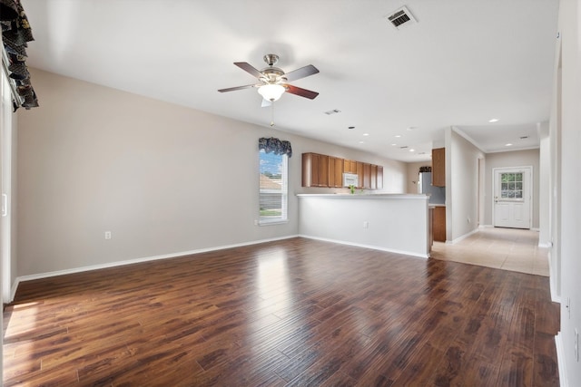 unfurnished living room featuring ceiling fan and light tile patterned floors