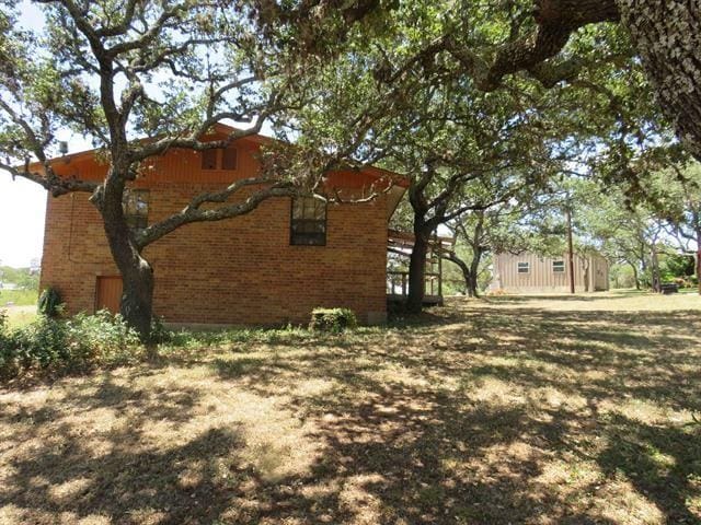 view of home's exterior with brick siding