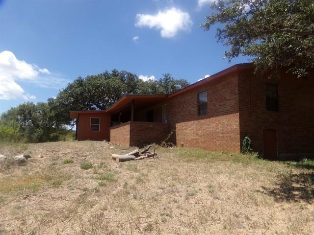105 E Fawn Dr, Buchanan Dam, TX 78609 - view of side of home featuring brick siding