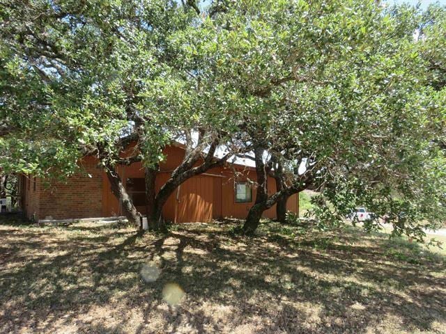 view of side of property with brick siding