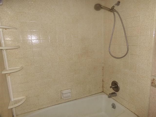 details with tiled shower / bath combo