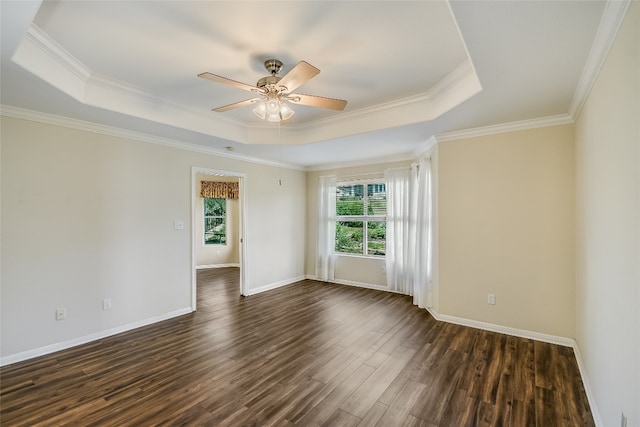 spare room featuring ceiling fan, crown molding, dark hardwood / wood-style flooring, and a raised ceiling