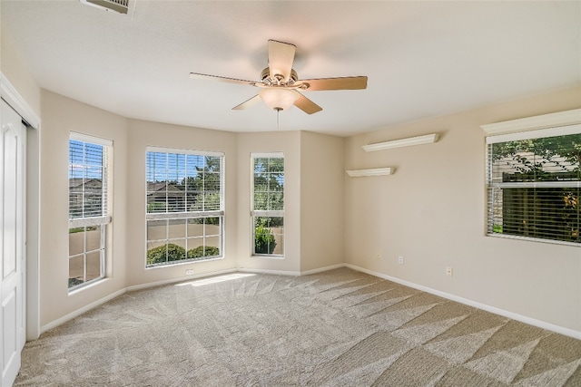 spare room featuring ceiling fan and carpet floors