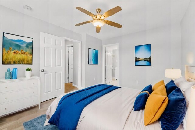 bedroom with ceiling fan, light hardwood / wood-style flooring, and ensuite bath