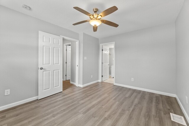 unfurnished bedroom with hardwood / wood-style floors and ceiling fan