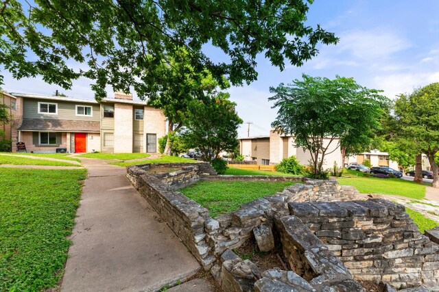 view of home's community featuring a lawn