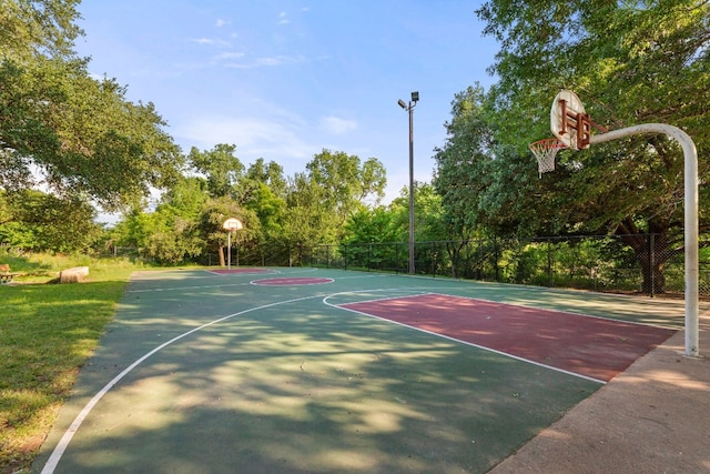 view of basketball court featuring community basketball court and fence