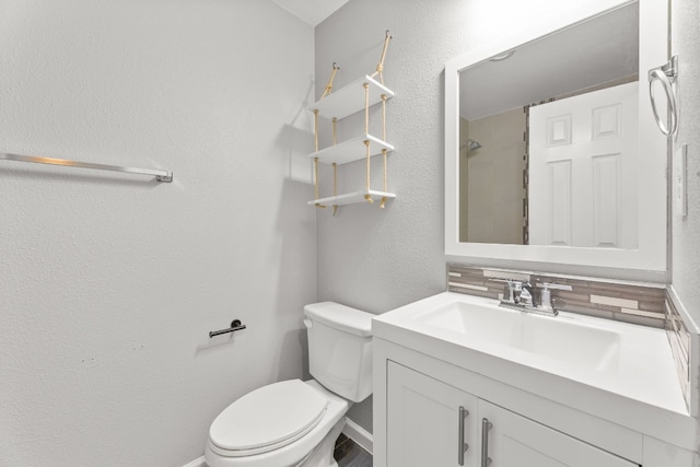 full bath featuring a textured wall, toilet, vanity, baseboards, and walk in shower