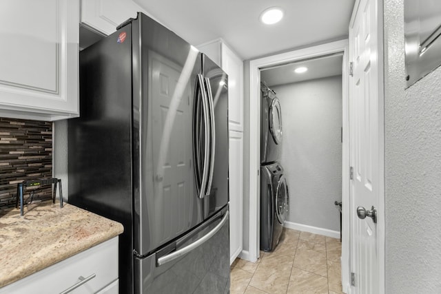 kitchen featuring backsplash, white cabinets, stainless steel refrigerator, and light tile patterned flooring