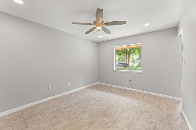 empty room featuring ceiling fan and light tile patterned flooring