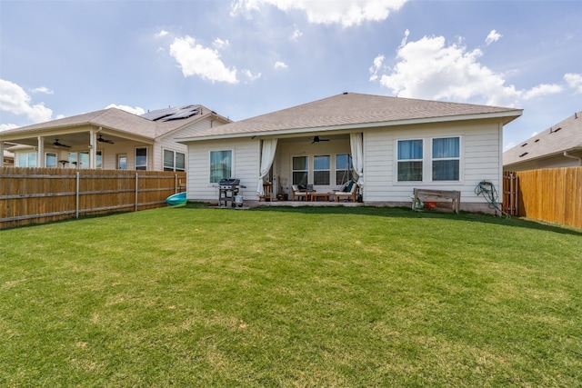 back of house with a lawn, a patio, solar panels, and ceiling fan