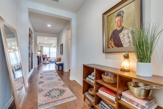 hallway with hardwood / wood-style floors