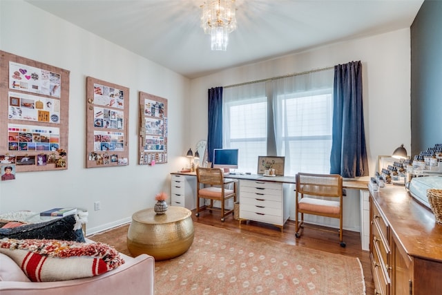 office with a notable chandelier and hardwood / wood-style floors