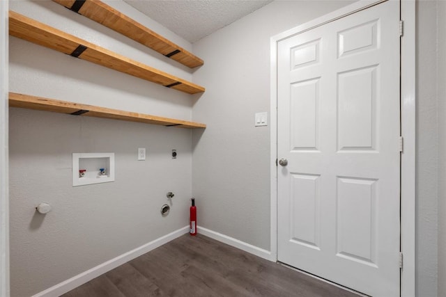 clothes washing area with gas dryer hookup, dark wood-type flooring, a textured ceiling, washer hookup, and hookup for an electric dryer