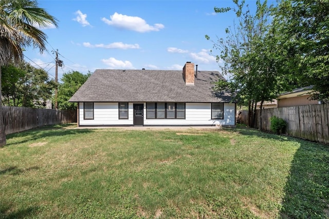 back of house with a lawn