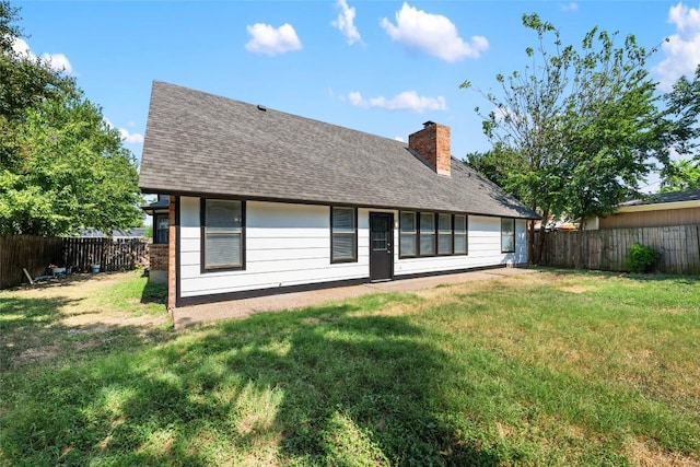 back of house with a lawn