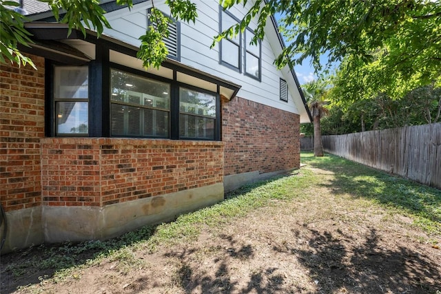 view of side of property with a lawn