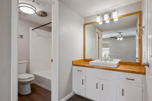 full bathroom with hardwood / wood-style flooring, vanity, toilet, and a textured ceiling