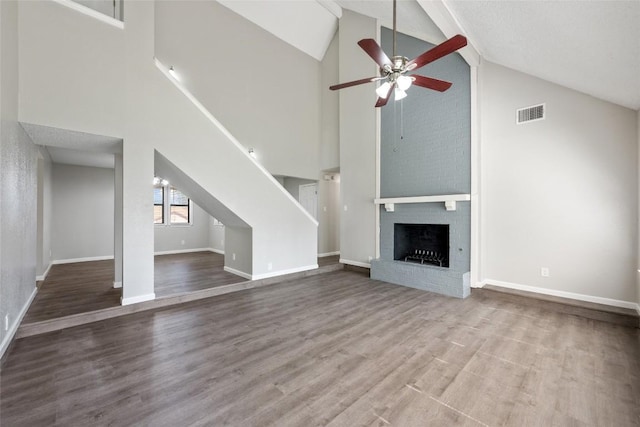 unfurnished living room with a fireplace, ceiling fan, lofted ceiling, and hardwood / wood-style floors