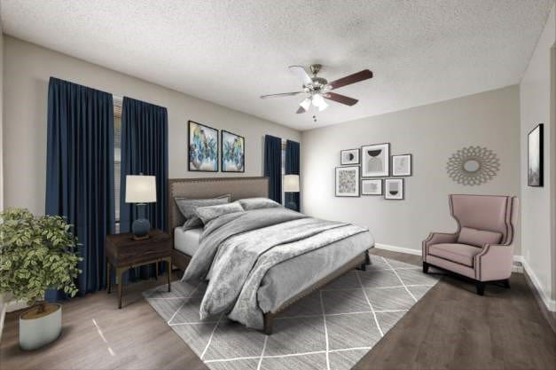 bedroom with hardwood / wood-style flooring, ceiling fan, and a textured ceiling