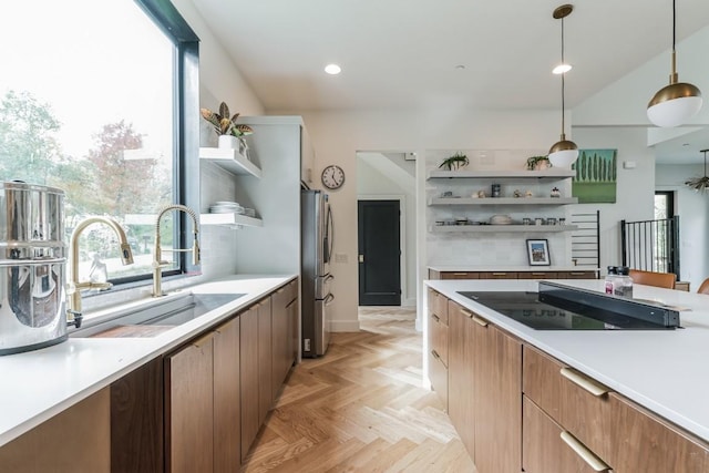 107 Blue Ridge Trl, Austin, TX 78746 - kitchen featuring open shelves, black electric cooktop, a sink, freestanding refrigerator, and light countertops