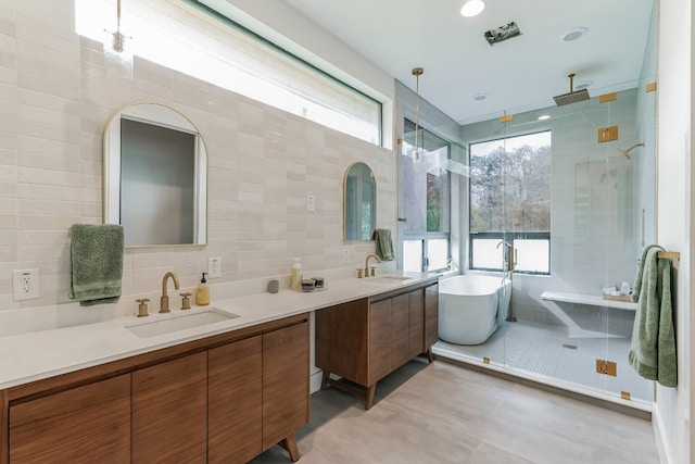 107 Blue Ridge Trl, Austin, TX 78746 - bathroom with tile walls, double vanity, a shower stall, a soaking tub, and decorative backsplash