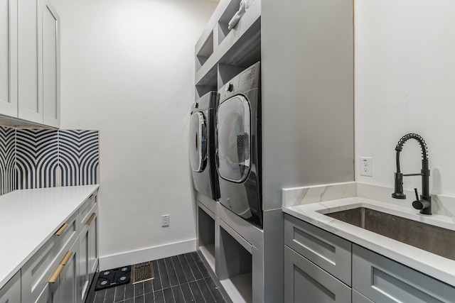 107 Blue Ridge Trl, Austin, TX 78746 - washroom with washer and dryer, dark tile patterned floors, and cabinet space