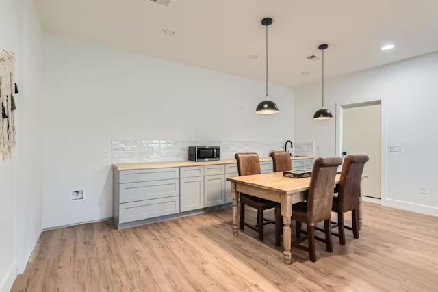 107 Blue Ridge Trl, Austin, TX 78746 - dining area featuring light wood-type flooring, baseboards, and recessed lighting
