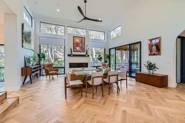 107 Blue Ridge Trl, Austin, TX 78746 - dining room with a high ceiling, baseboards, ceiling fan, arched walkways, and recessed lighting