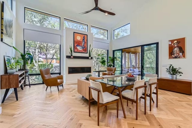 107 Blue Ridge Trl, Austin, TX 78746 - dining room with a towering ceiling, a ceiling fan, and baseboards