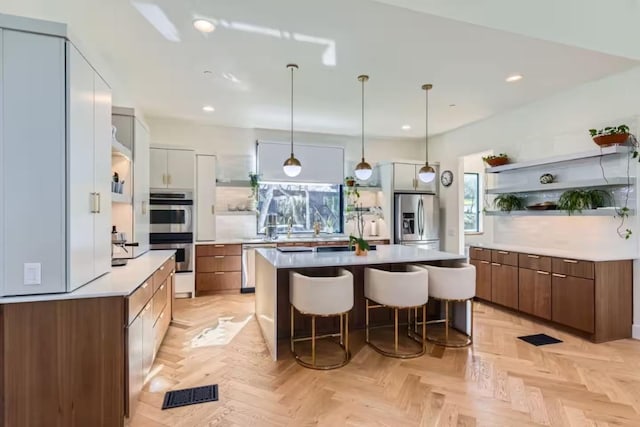 107 Blue Ridge Trl, Austin, TX 78746 - kitchen with stainless steel appliances, a kitchen bar, open shelves, plenty of natural light, and recessed lighting