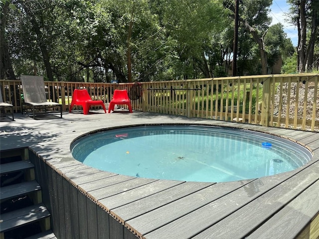 107 Blue Ridge Trl, Austin, TX 78746 - outdoor pool featuring a deck and view of wooded area