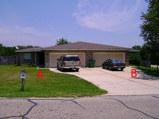 ranch-style home featuring a garage and a front yard