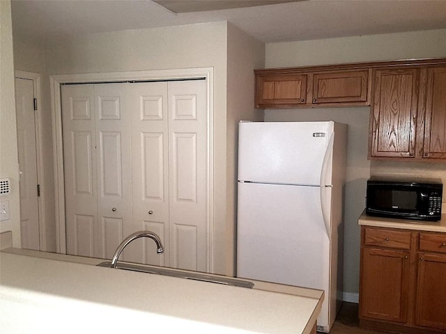 kitchen featuring sink and white refrigerator