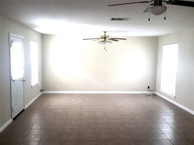 unfurnished room with a healthy amount of sunlight and ceiling fan