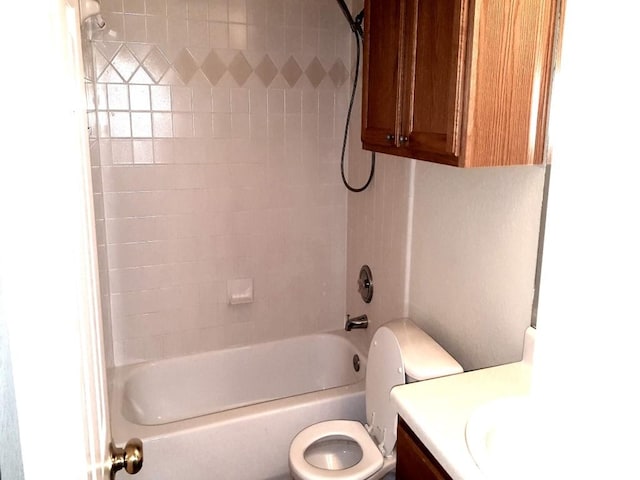 full bathroom with toilet, vanity, and tiled shower / bath