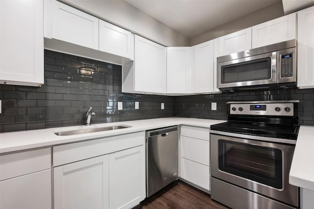 935 La Posada Dr Unit 115, Austin, TX 78752 - kitchen with stainless steel appliances, a sink, light countertops, and white cabinets